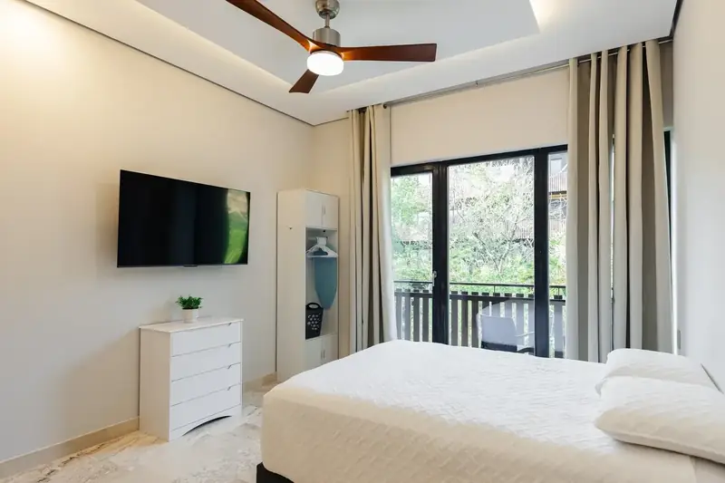 Bedroom with queen bed and a window to the green